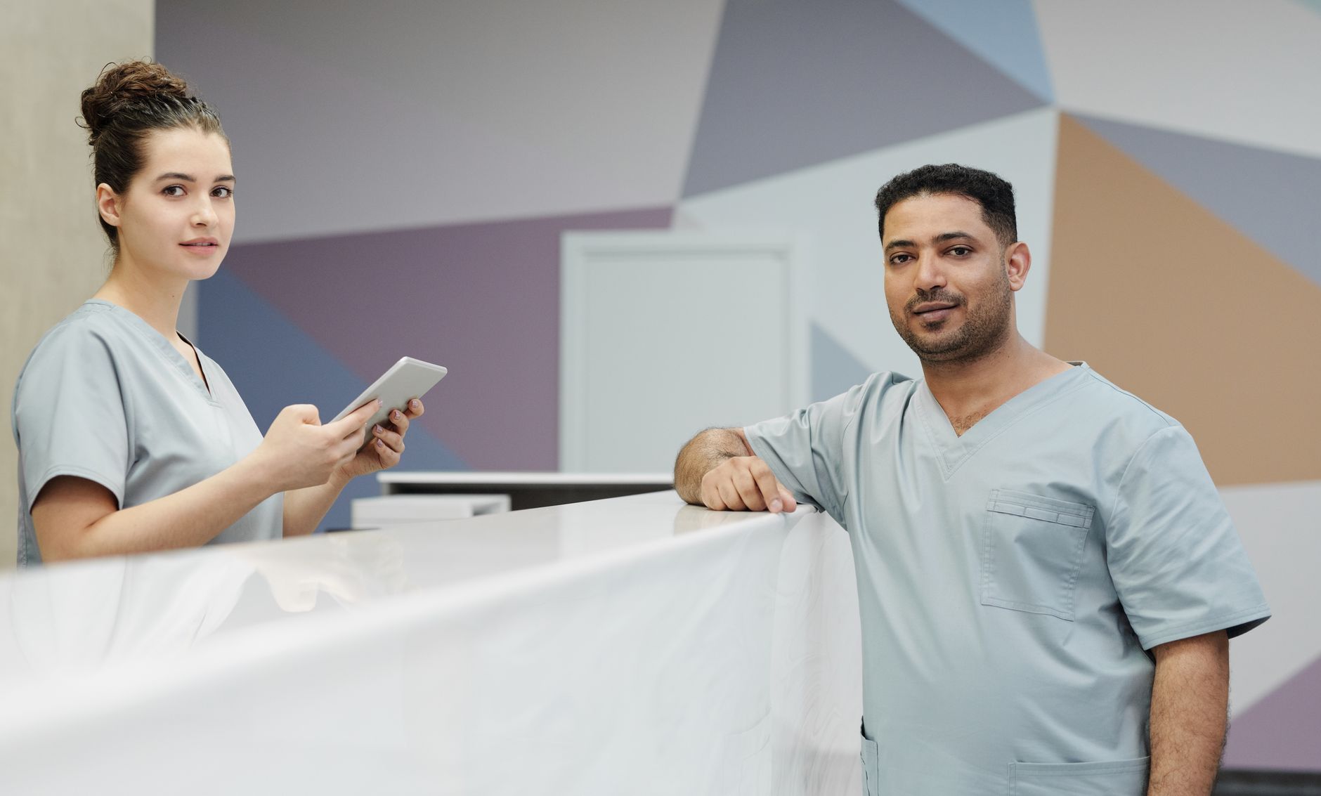A patient coordinator using WhatsApp on a smartphone to follow up with an international patient enquiry from the UK