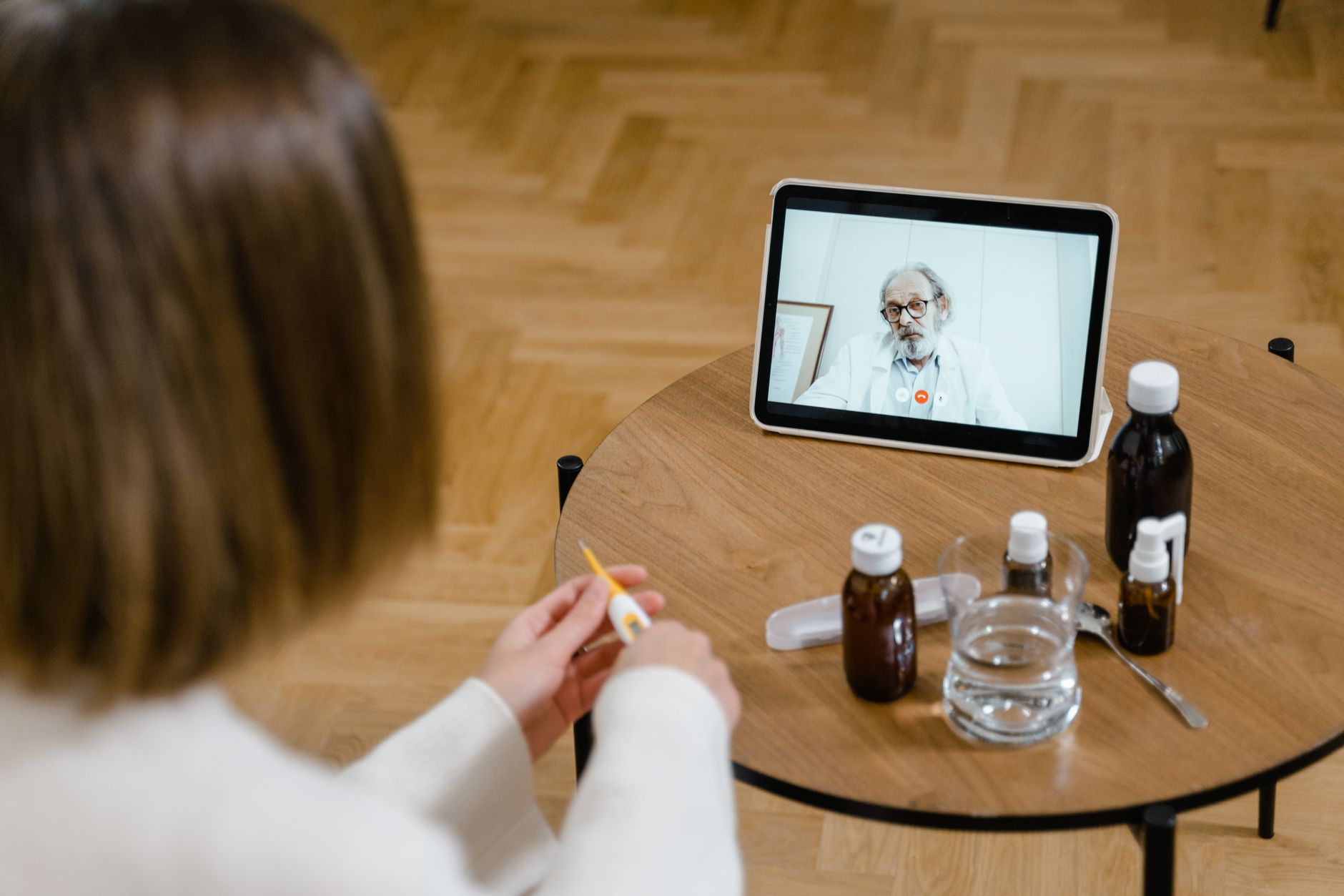 A clinic coordinator conducting a video consultation with a UK patient, representing cross-border medical communication
