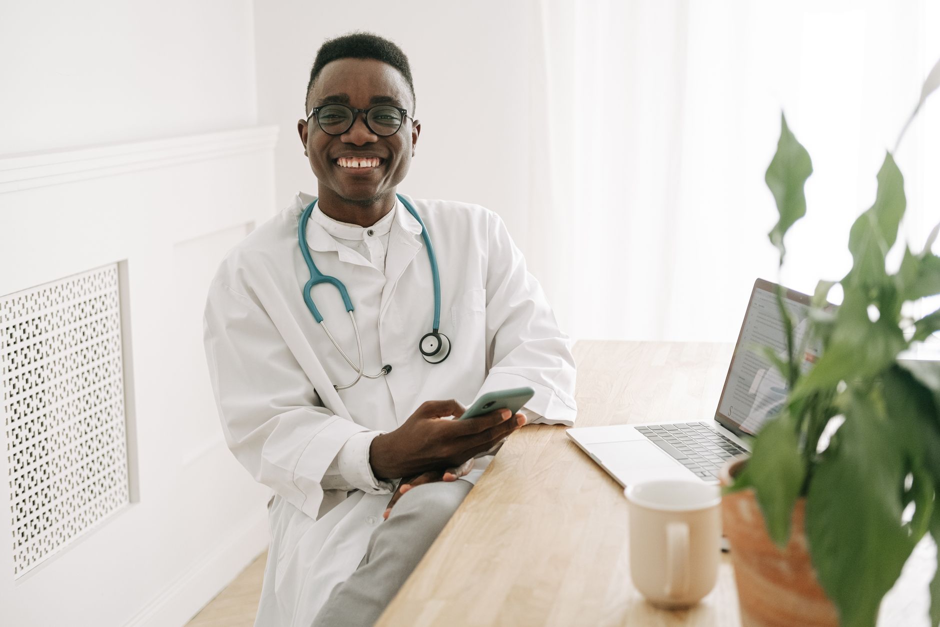 A clinic coordinator using WhatsApp on a smartphone to follow up with an international patient enquiry