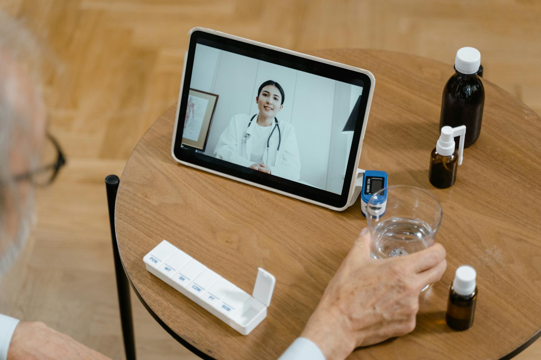 A clinic doctor conducting a remote video follow-up consultation with a UK patient after overseas treatment