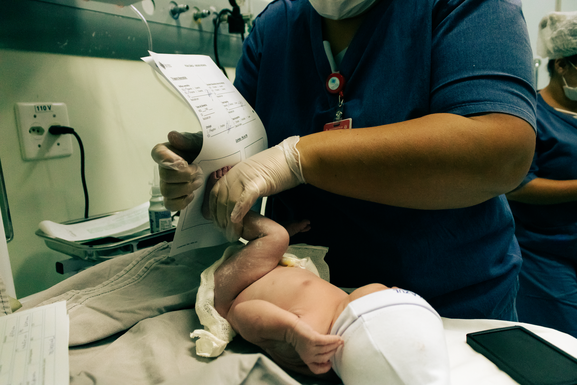 A clinic manager reviewing ISO accreditation documentation at a modern medical facility