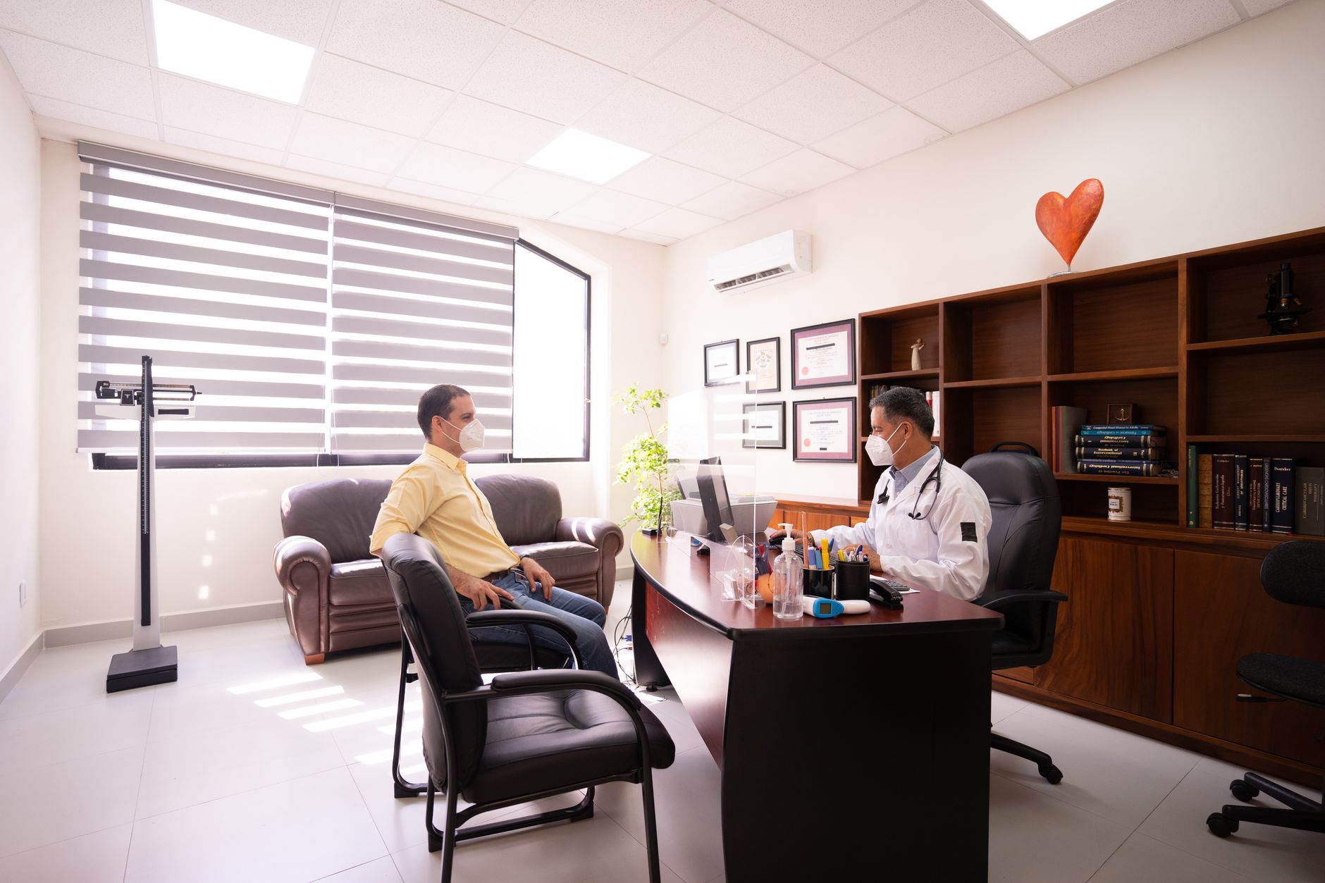 A patient coordinator using AI-assisted chat software to respond to an international patient enquiry on a laptop screen