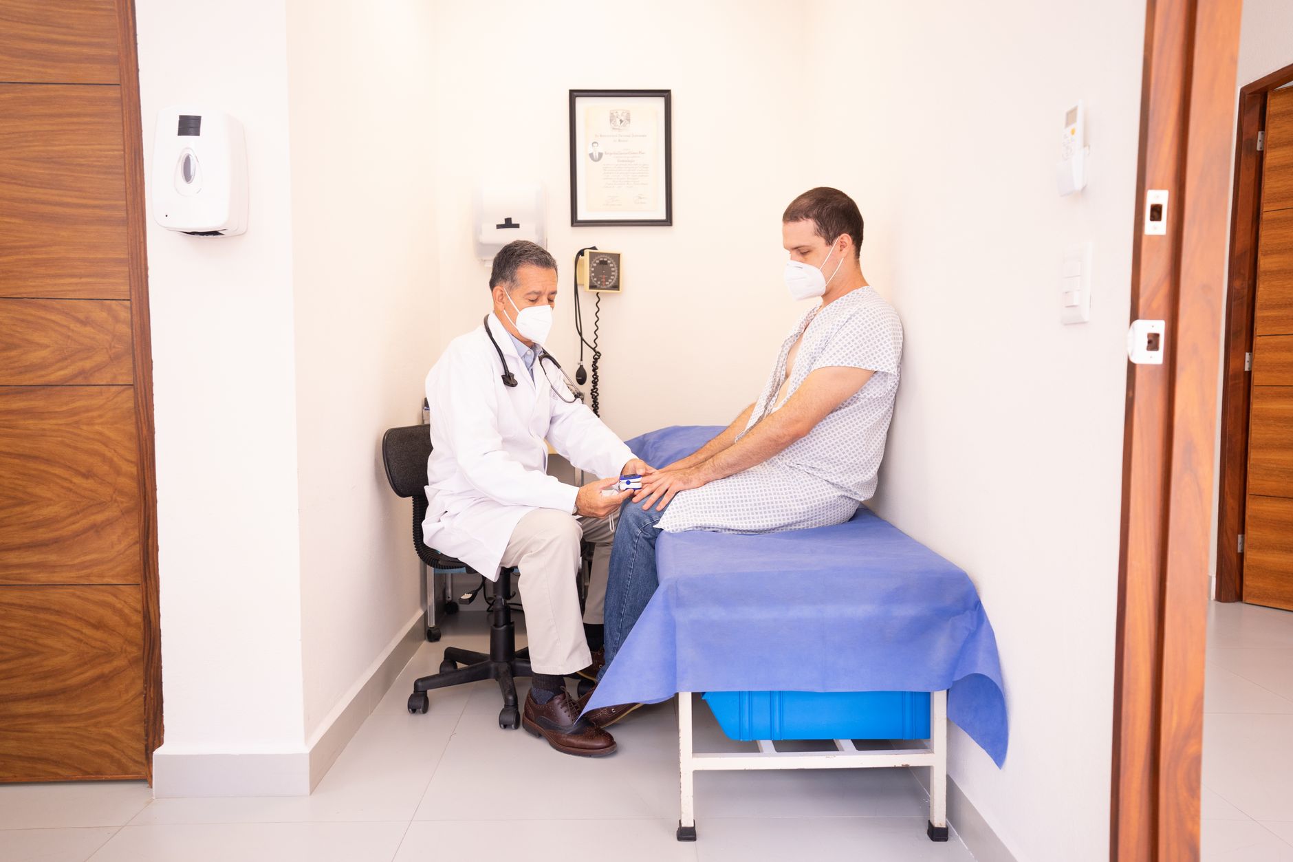 A patient coordinator at an international clinic reviewing a UK patient's enquiry on a laptop during a video consultation