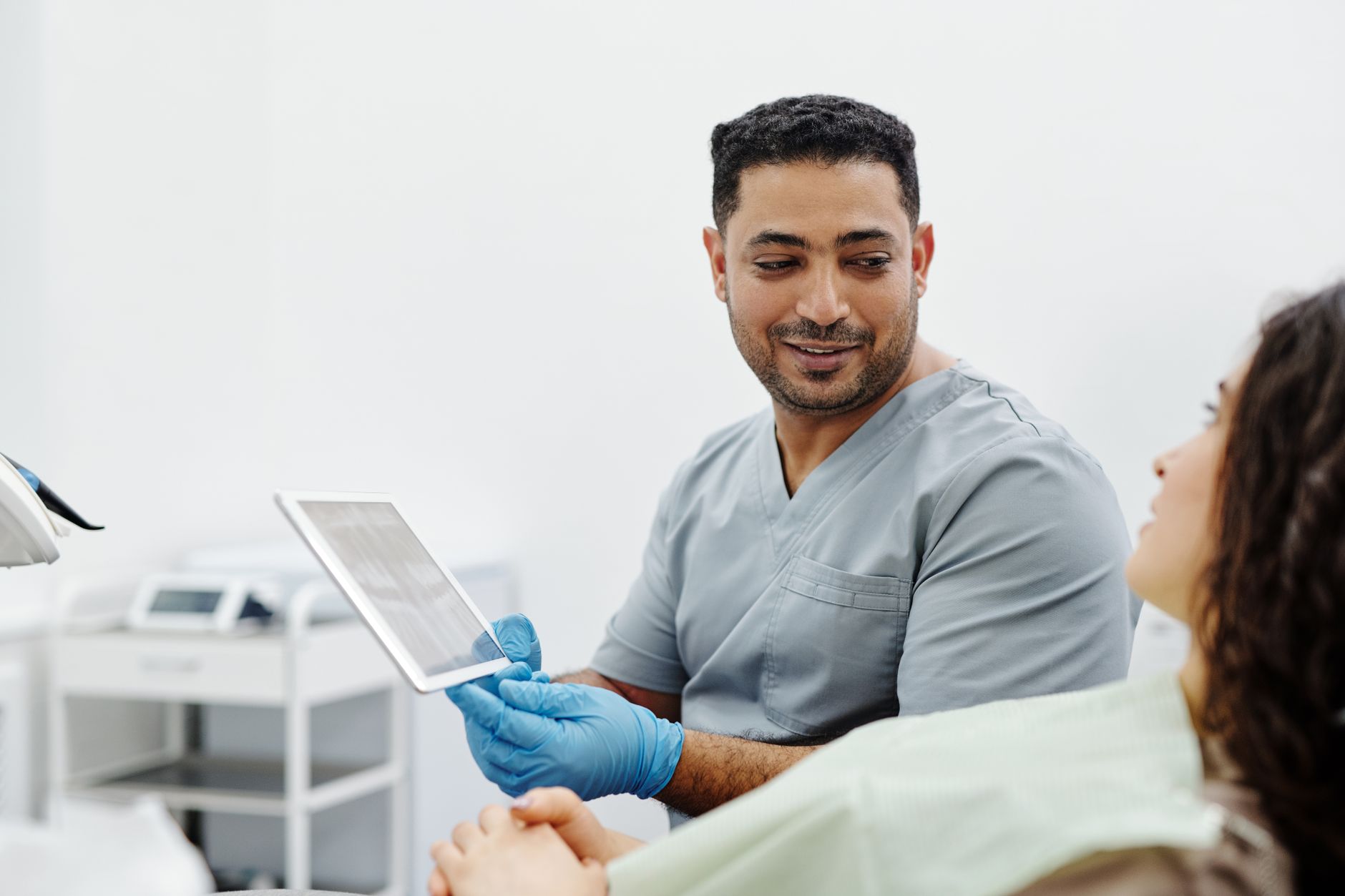 A patient coordinator at an international clinic speaking with a UK patient via video consultation, representing multilingual patient communication in medical tourism