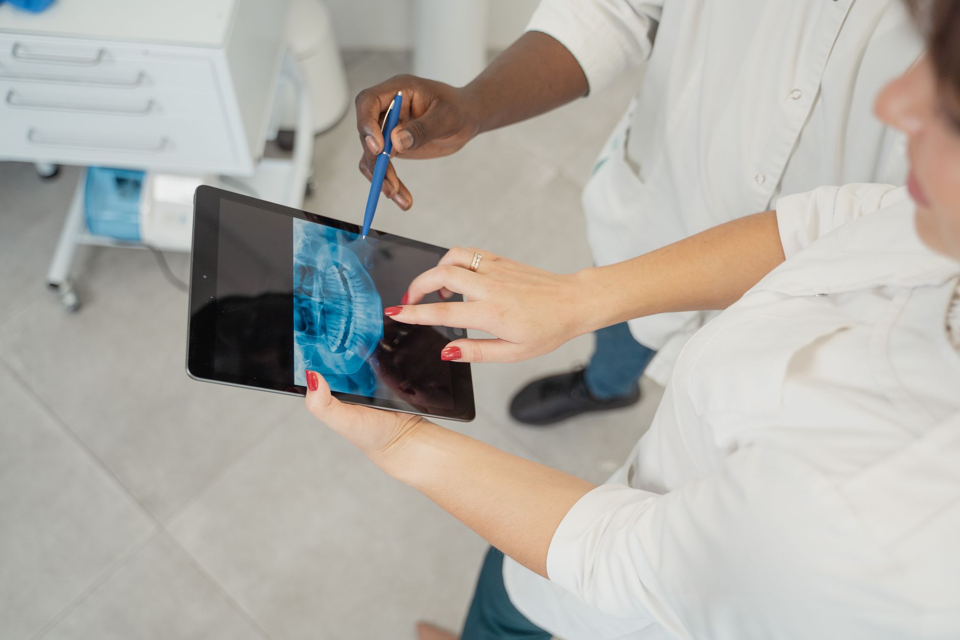 A clinic marketing manager reviewing AI-powered patient acquisition dashboards on a laptop in a modern medical office