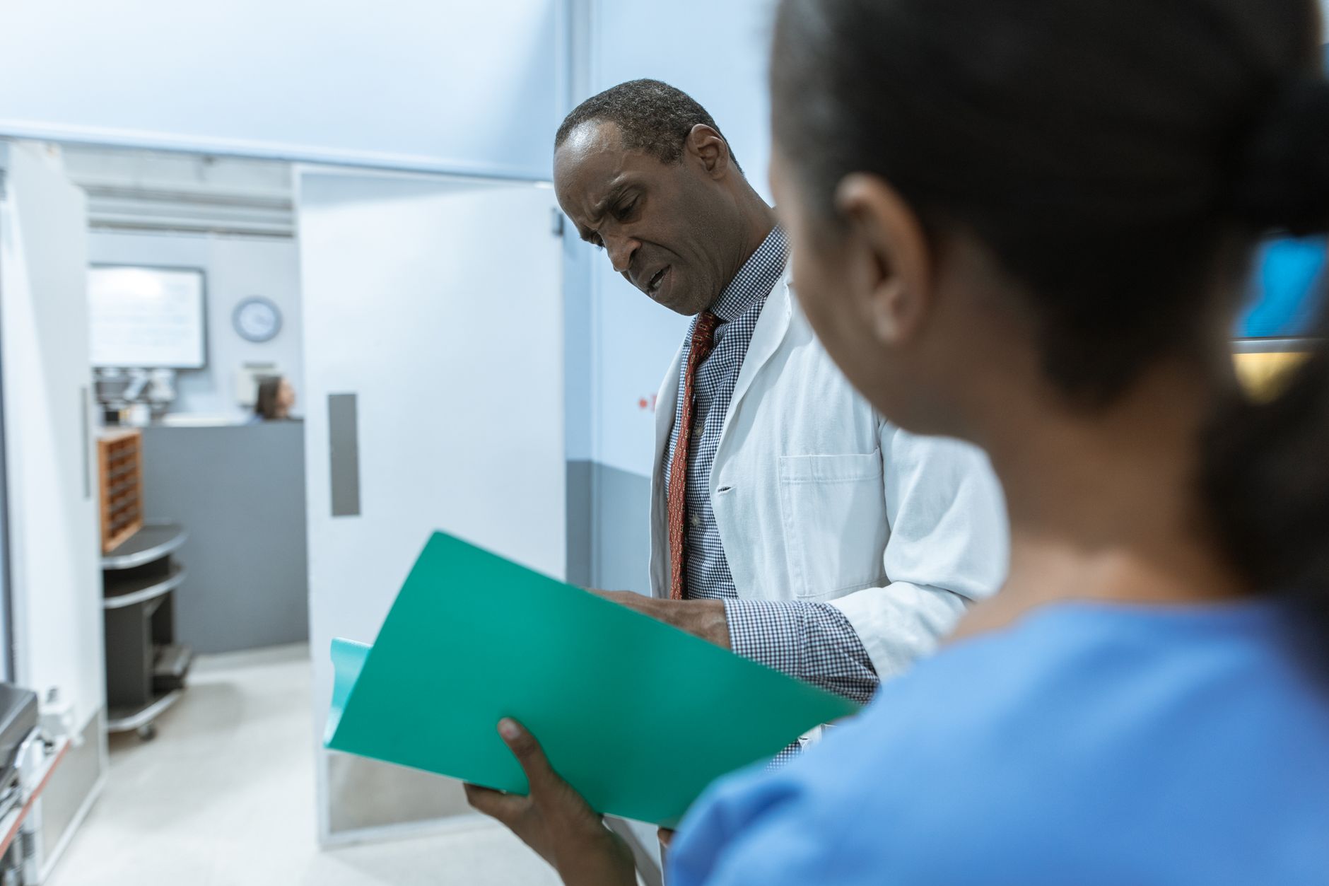 A clinic manager reviewing patient feedback on a tablet, representing online review management for international healthcare providers targeting UK patients