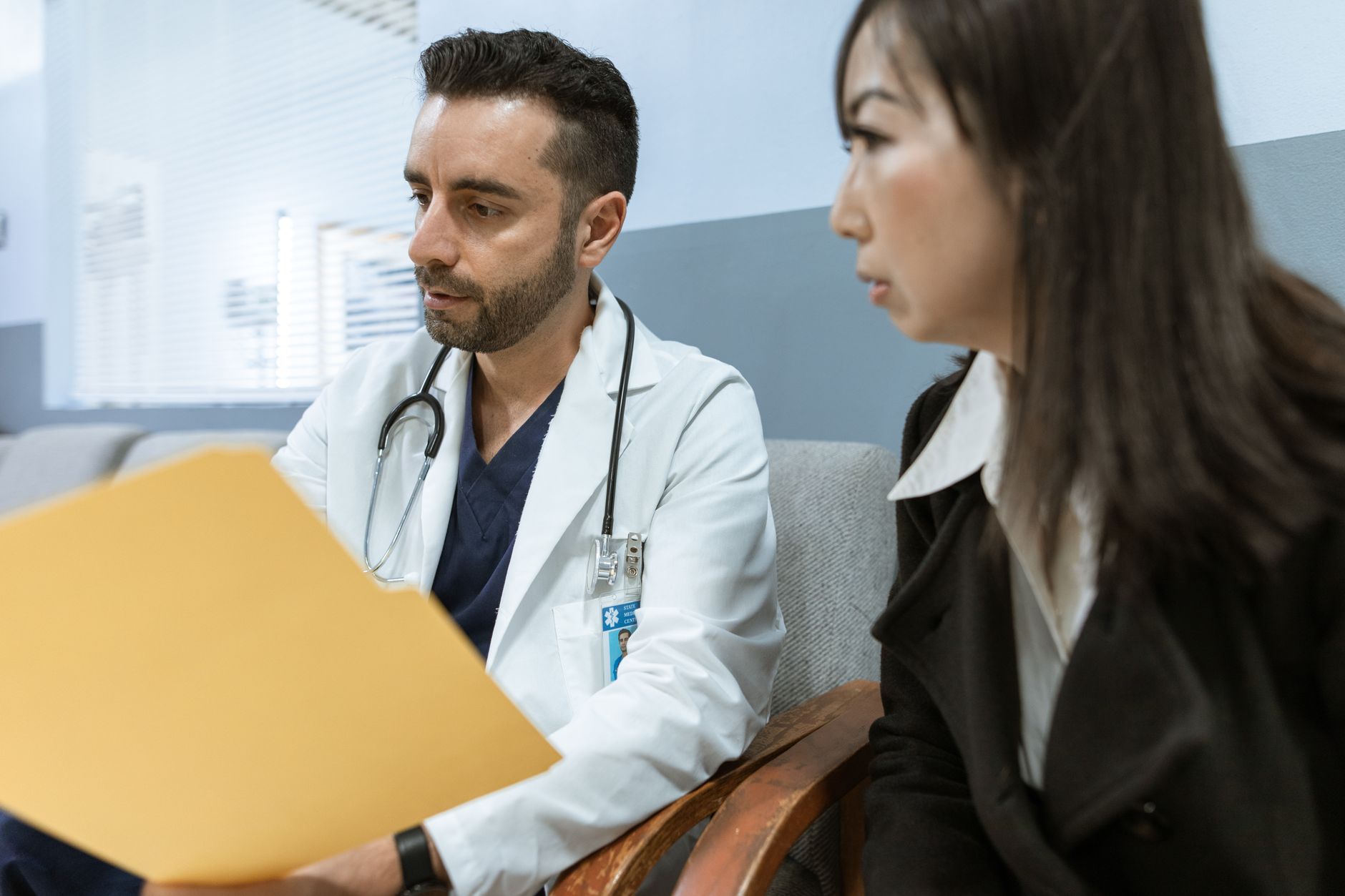 A clinic consultant speaking with a UK patient via video call, reviewing treatment options on a laptop screen