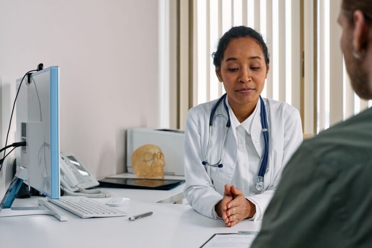 A clinic patient coordinator reviewing AI chatbot enquiries on a laptop to convert UK patient bookings